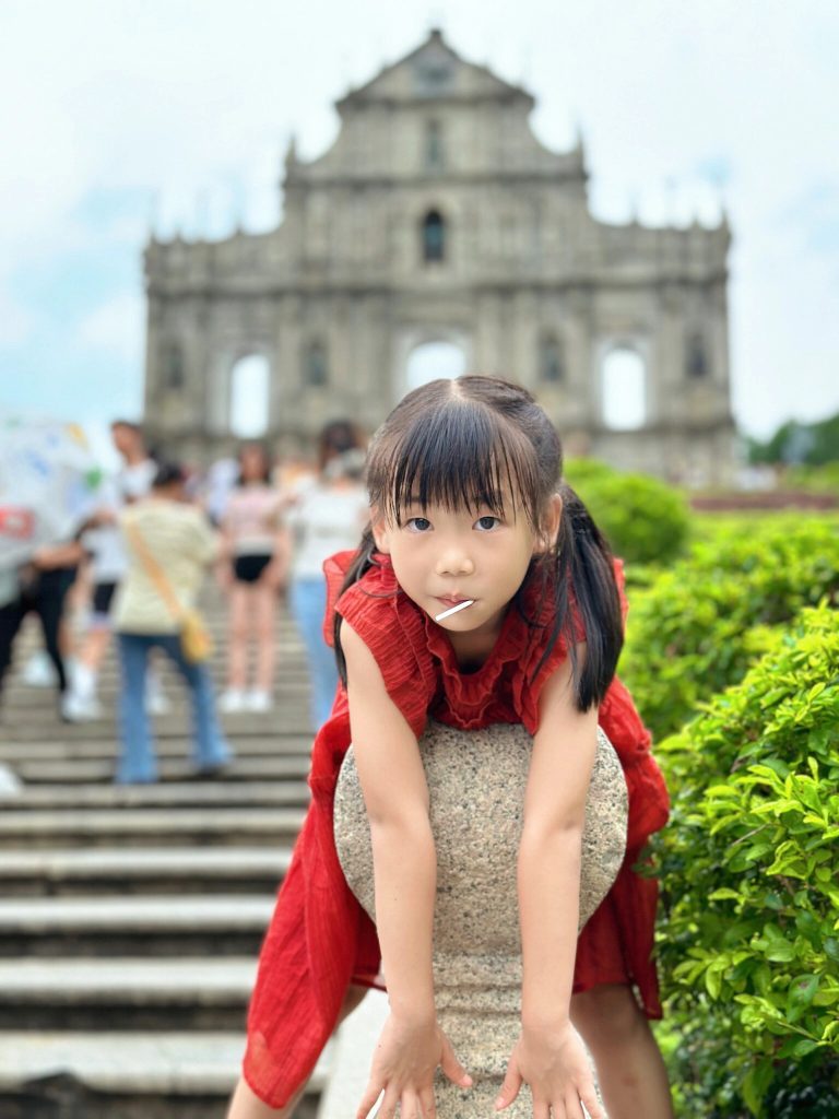 Child exploring Macau historic street
