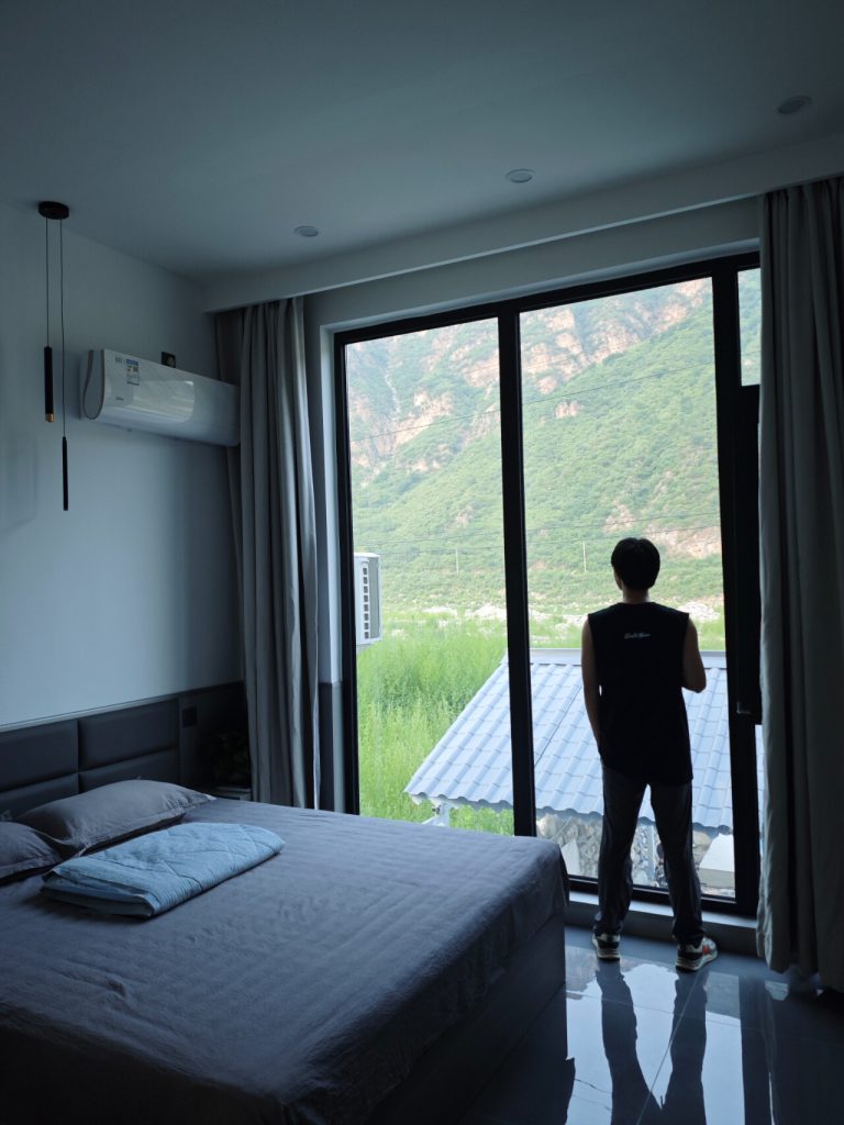 Bedroom with mountain view through glass doors