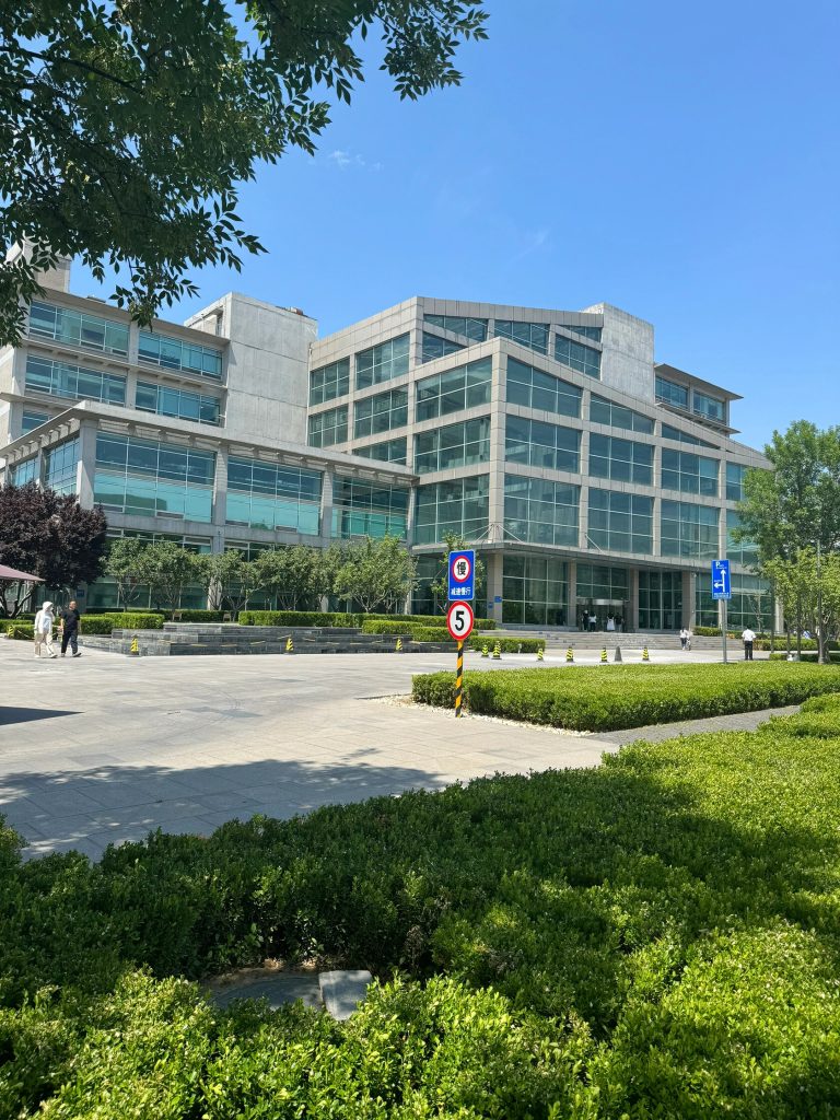 Glass-fronted building exterior with greenery