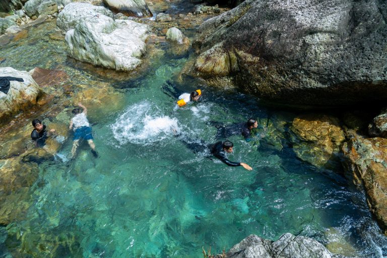 People playing in clear stream
