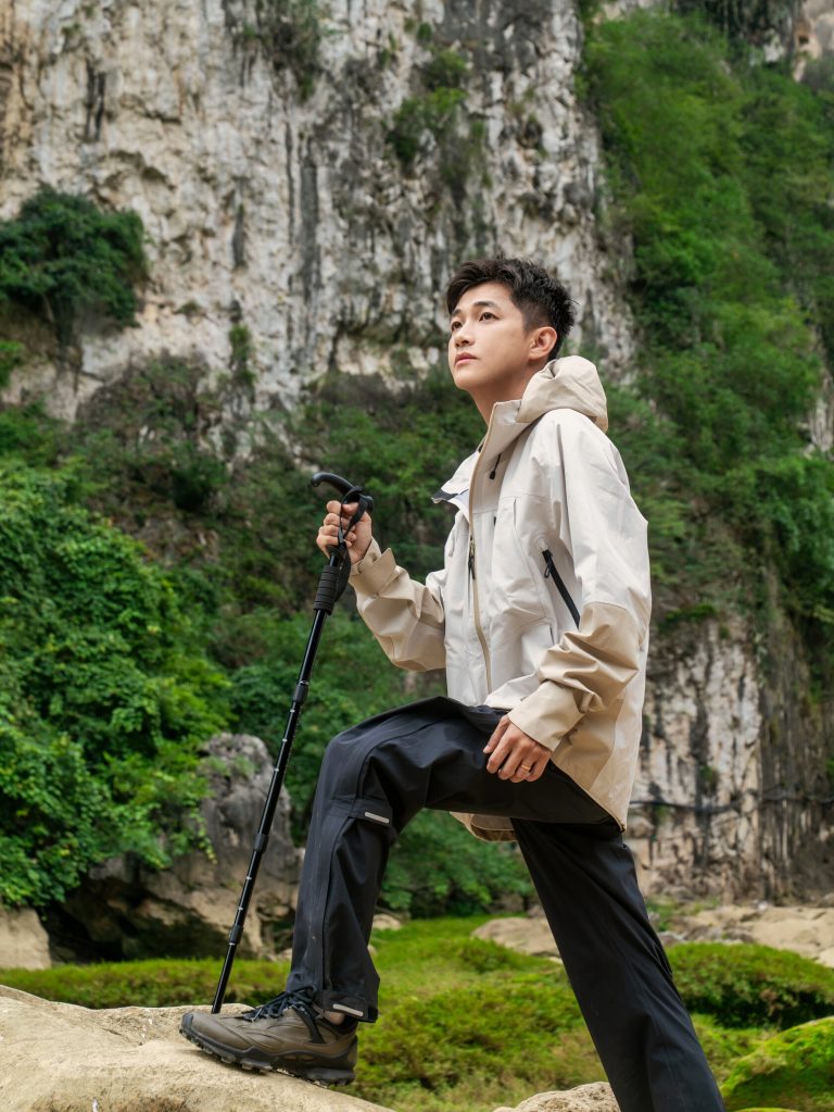 Person standing on rocks with mountain backdrop