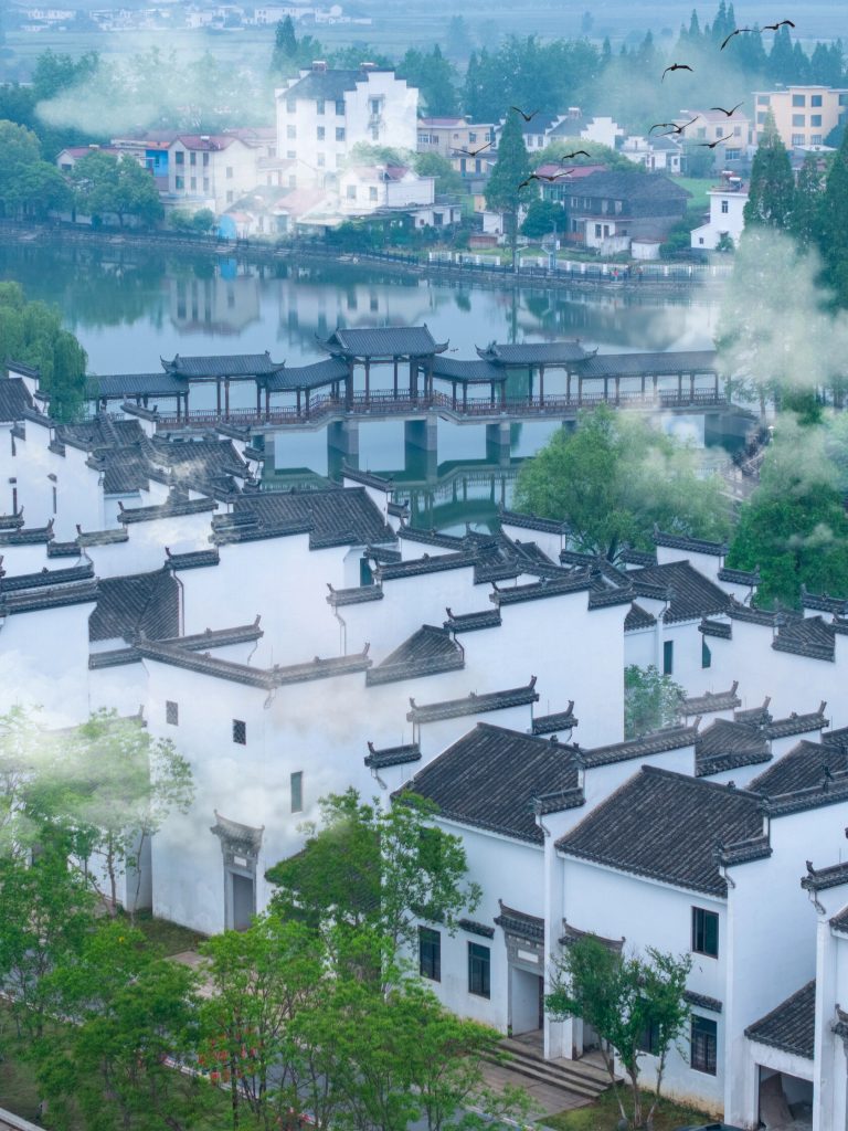 Traditional architecture reflected in misty lake