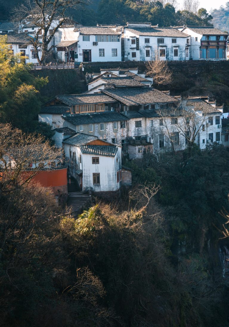 Traditional white village nestled in misty mountains