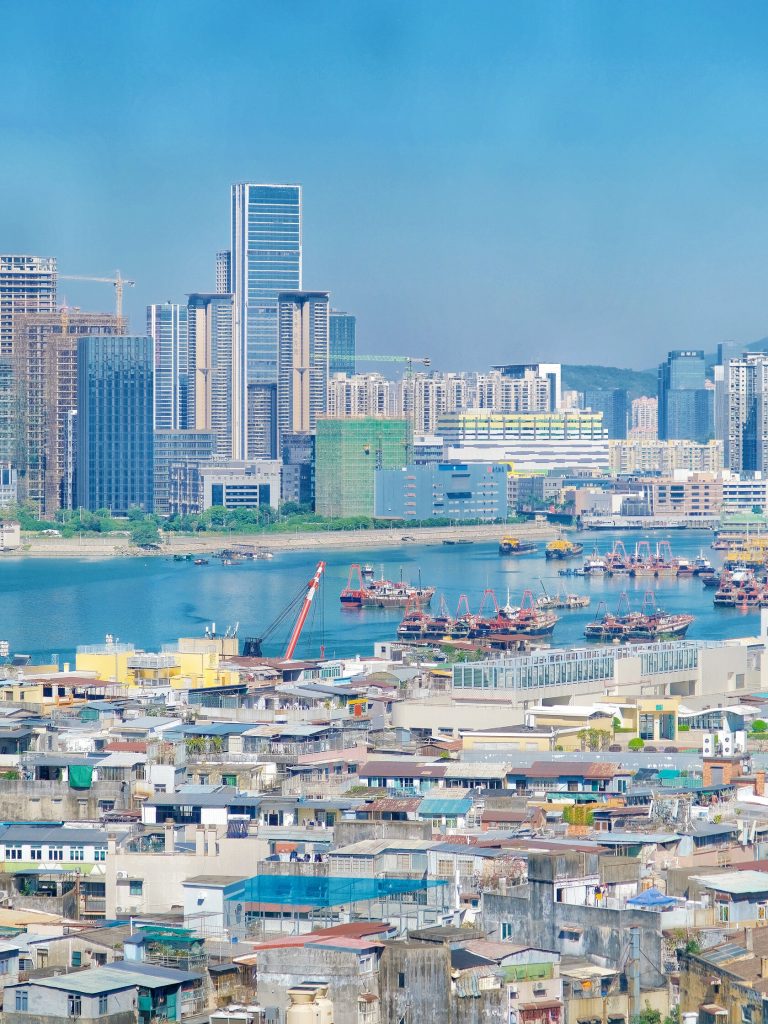 Cityscape with river and construction cranes