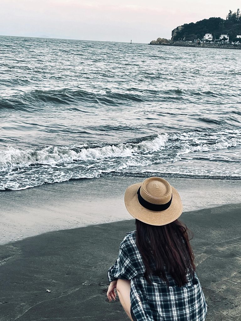 Person in hat facing the sea at Hac Sa Beach
