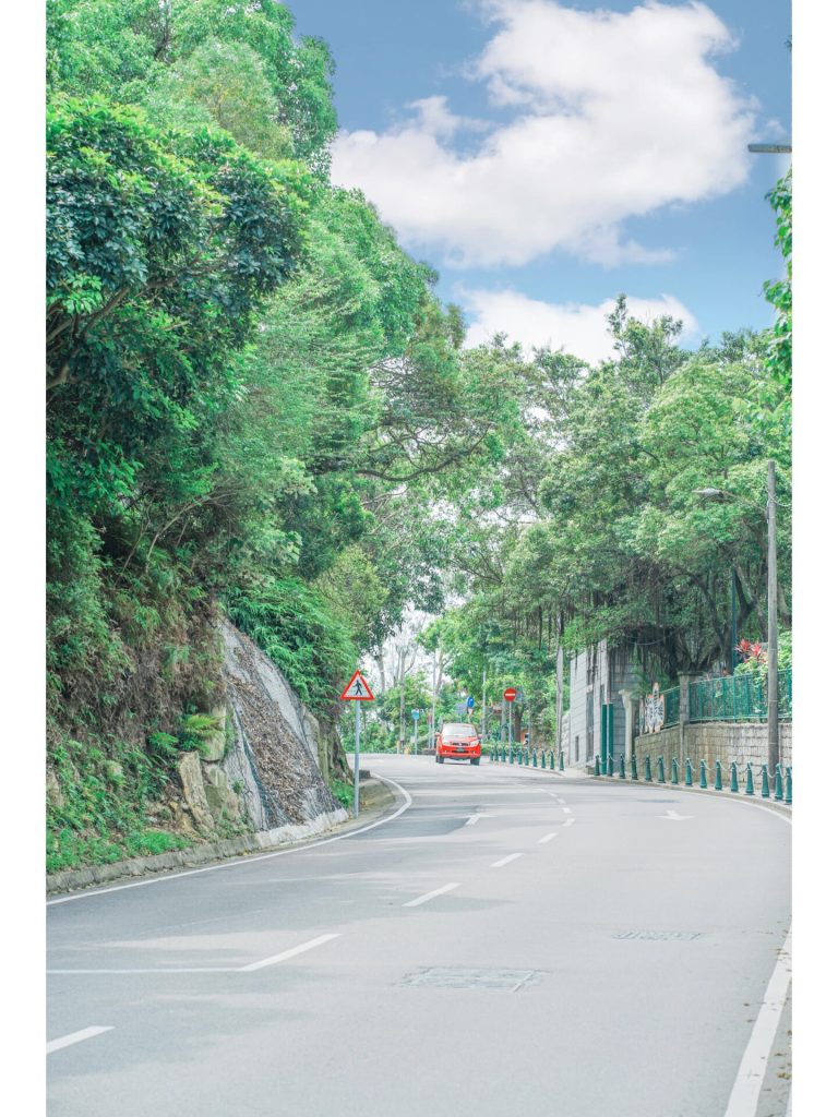 Winding mountain road with red car
