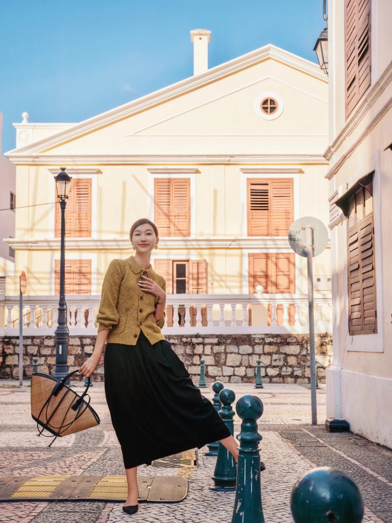 Woman in yellow coat on European-style street