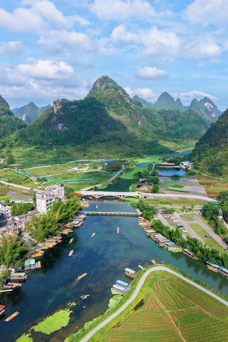 Scenic river landscape with mountains and boats