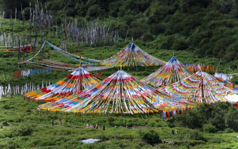 Tibet high altitude trekking starting point with prayer flags
