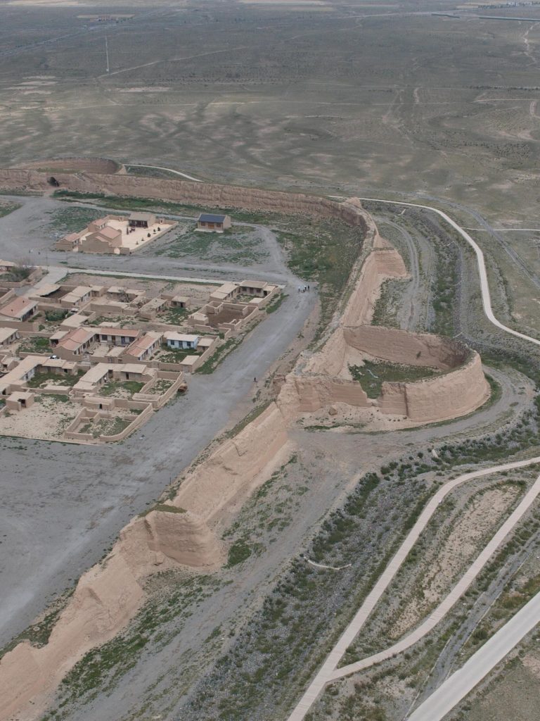 Aerial view of Yongtai Ancient City, a crumbling fortress against the vast desert, a powerful image of the Northwest China Odyssey.